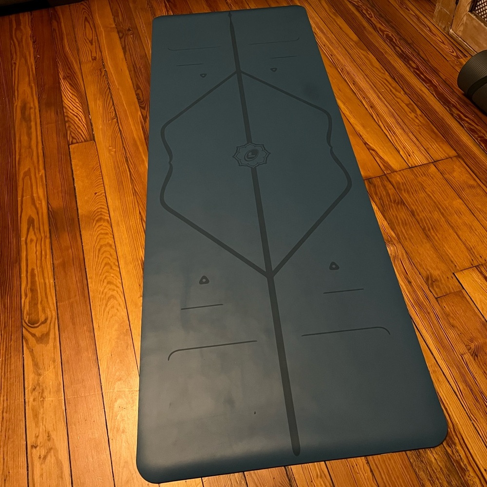 Peacock blue liforme yoga mat in carrier bag
